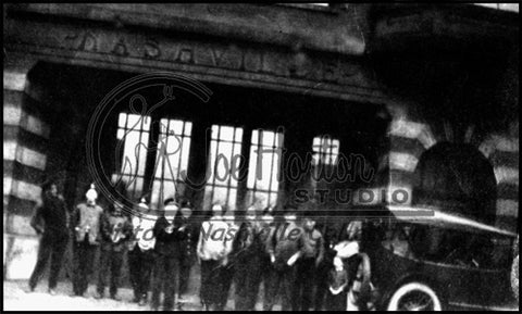 Men Standing in Front of a Fire Hall