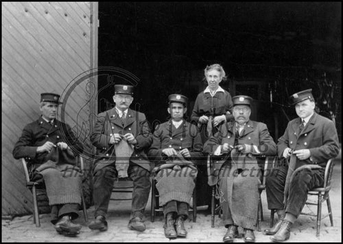 Firemen Knitting in Front of Fire Hall